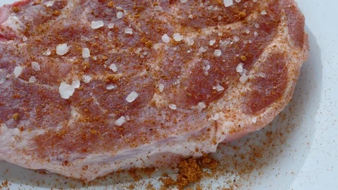 Raw meat is ready to grill-sprinkled with red pepper, salt, white pepper Stock Footage 98194607