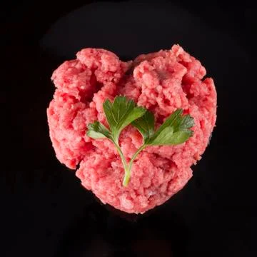 Raw meat in shape of heart Stock Photos