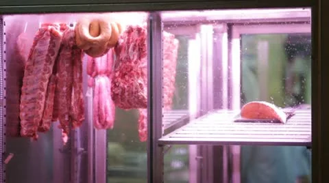 Raw meat on shop window Stock Footage 12581721