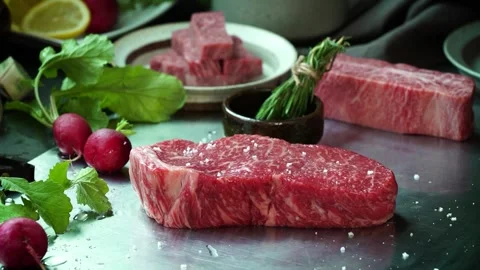 The raw meat is sprinkled with salt. Stock Footage 334358082