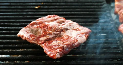 Raw meat steak is cooked on grid with blood. BBQ grill beef or pork kebab. Stock Footage 139205234