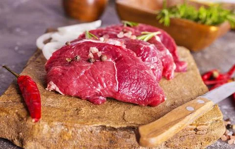 Raw meat on a table with spices Stock Photos