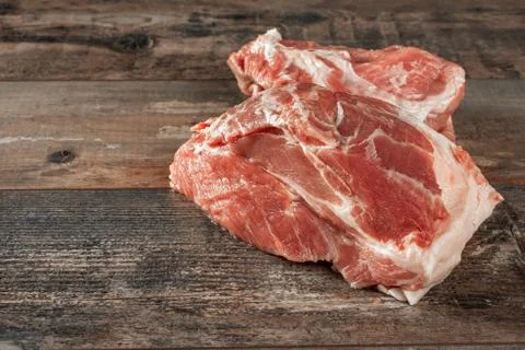 Raw meat. two pieces of raw pork on a wooden rustic table background. copy sp Stock Photos
