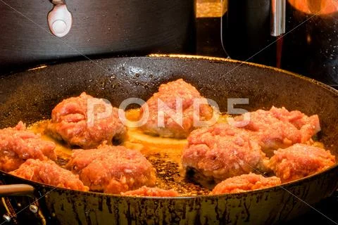 Raw Meatballs On A Frying Pan
