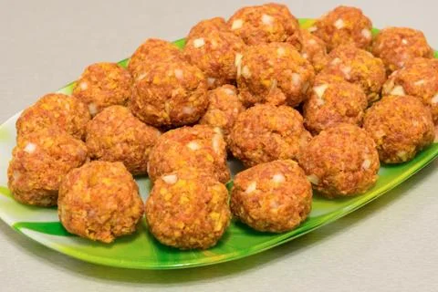 Raw meatballs on a platter close up Stock Photos