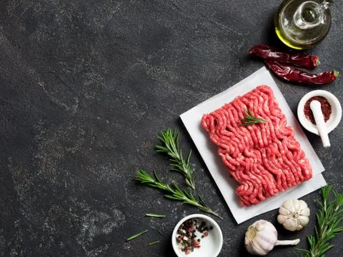 Raw minced beef on light gray cement background 库存照片
