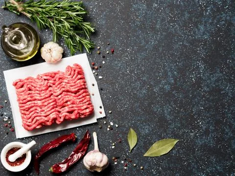 Raw minced beef on light gray cement background Фото