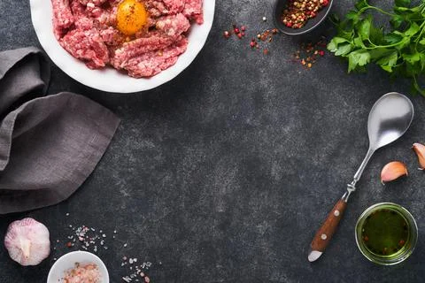 Raw minced meat. Ground meat beef, pork or lamb spices, herbs and eggs on whi Stock Photos