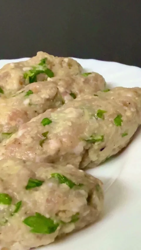 Raw minced meat kebabs with herbs on white plate Video stock 331974828