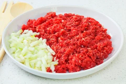 Raw minced or ground beef with onions Stock Photos