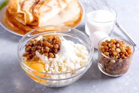 Raw mixture for making cheesecakes. Cottage cheese, raisins, egg yolk Stock Photos