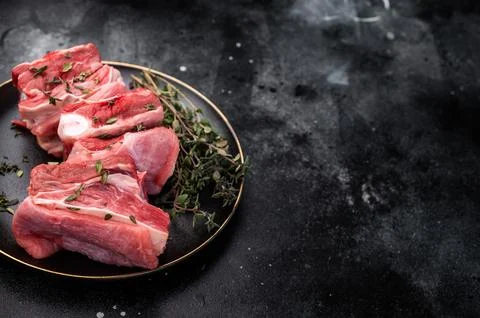 Raw mutton cut rib chops, fresh lamb meat with herbs for grilling. black ba.. Stock Photos