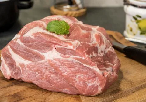 Raw neck pork on kitchen table ready to be cut and cook. Stock Photos