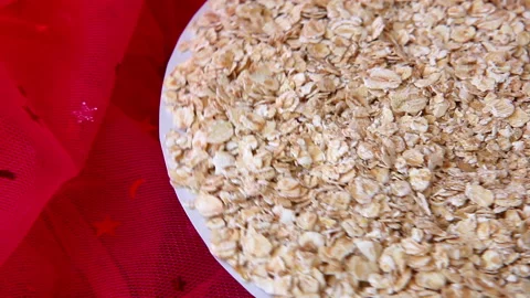 Raw oatmeal flakes move around on pink background with copy space 動画素材 169047778