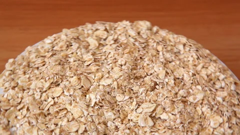 Raw oatmeal flakes move around, healthy food Stock-Footage 169048181