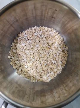 Raw oatmeal in a pan Stock Photos