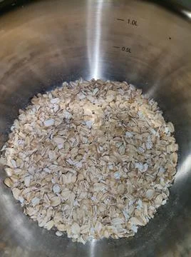 Raw oatmeal in a pan Stock Photos