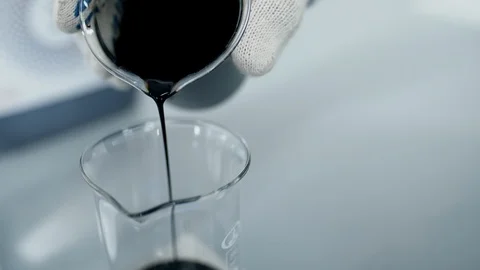 Raw oil sample research in laboratory. Scientist hand glass of black crude oil Stock Footage 116040248