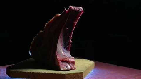 Raw old beef ribeye turning for presentation Stock Footage 137399031