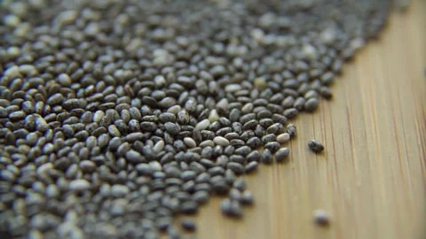 Raw organic chia seeds spread on a wooden table Stock Footage 333835842