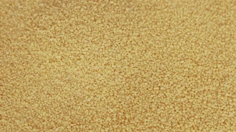 Raw organic couscous grains fall and crumble. Stock Footage 139355035