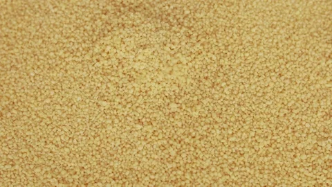 Raw organic couscous grains fall and crumble. Couscous background. Stock Footage 139355042