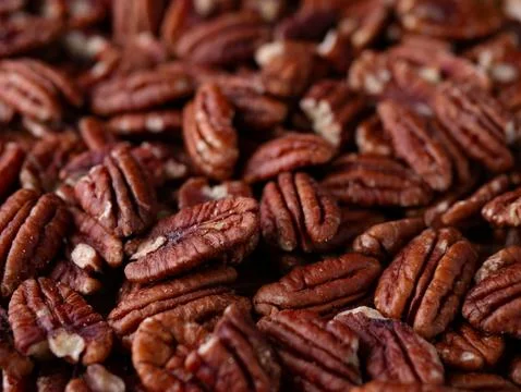 Raw organic pecan nuts pattern background. Stock Photos