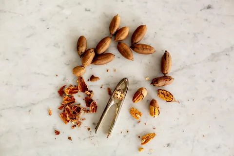 Raw organic pecans. Cracking the nuts. Stock Photos