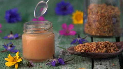 Raw organic royal jelly in small bottle and spoon pollen Stock Footage 80910782