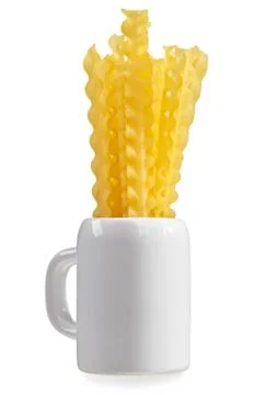 Raw pasta bunch composition in ceramic mug, isolated on white Foto stock