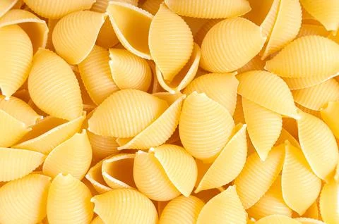 Raw pasta conchiglioni spaghetti pattern. Food background, italian cuisine Stock Photos