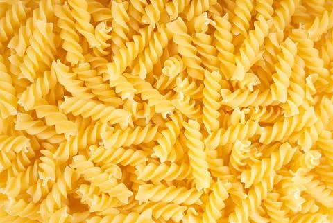 Raw pasta fusilli spaghetti pattern. Food background, italian cuisine Stock Photos