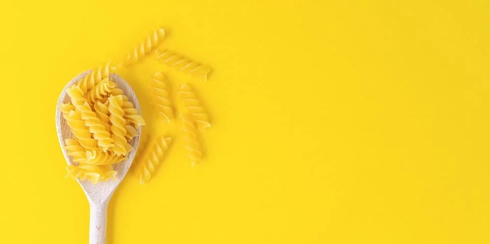 Raw pasta fusilli spaghetti pattern. Food background, italian cuisine Stock Photos
