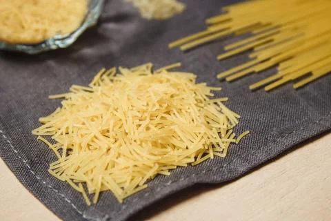 Raw pasta on gray background texture Stock Photos