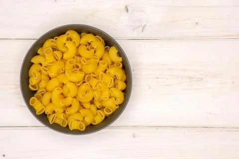 Raw pasta pipe rigate on grey wood Foto stock