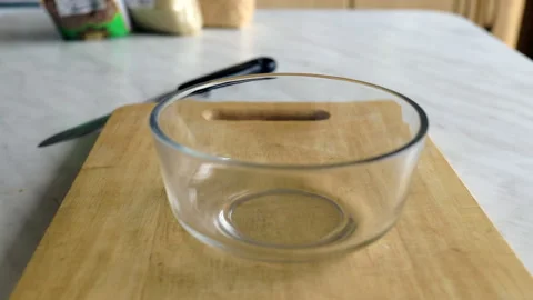 Raw pasta poured out of the bag into a transparent plate 库存影片 130940880