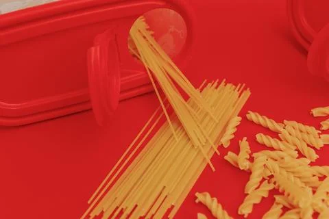 Raw pasta on red background Stock Photos