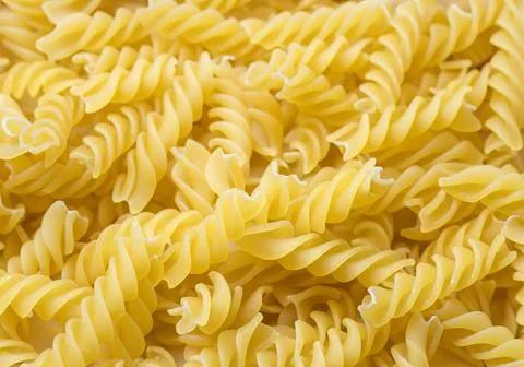 Raw pasta shapes and forms background.. Stock Photos