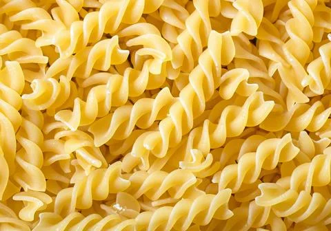Raw pasta shapes and forms background.. Stock Photos