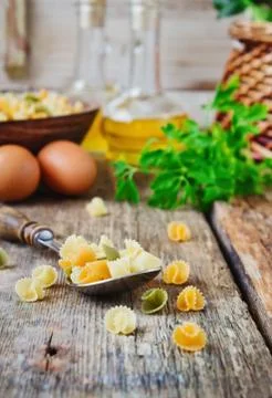 Raw pasta in a spoon Stock Photos