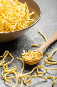 Raw pasta on spoon Stock Photos