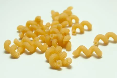 Raw pasta on a white background Stock Photos
