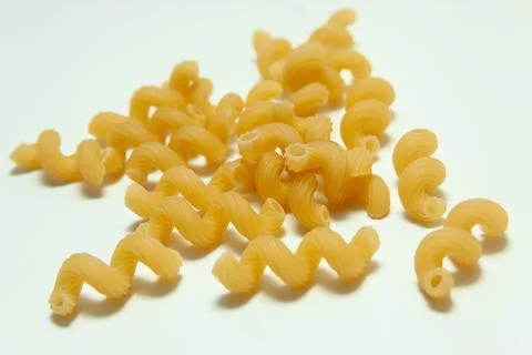 Raw pasta on a white background Stock Photos
