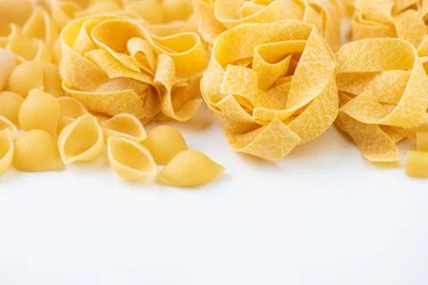 Raw pasta on white surface Stock Photos