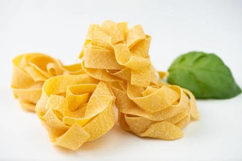 Raw pasta on white surface Stock Photos