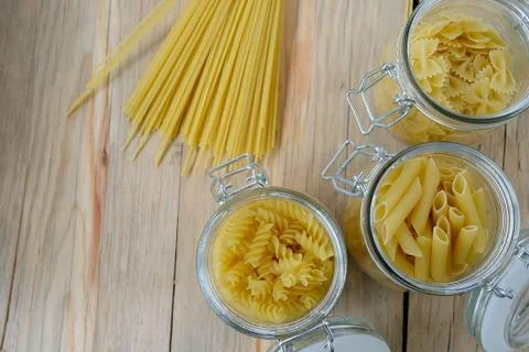 Raw pasta on wood background texture Stock-Fotos