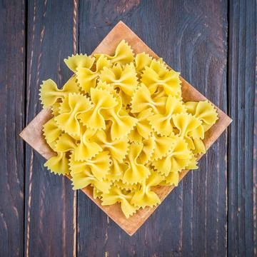 Raw pasta on wooden background - process old dark style picture Stock Photos