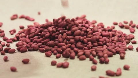 Raw peanuts falling down on a linen fabric Stock Footage 72125430