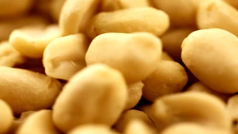 Raw peanuts, rotating on the surface. Overhead view. Colors out of camera. No co Stock Footage 94142993