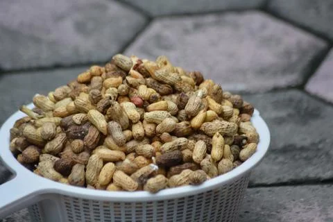 Raw Peanuts In Shell In White Basket Outdoors Stock Photos
